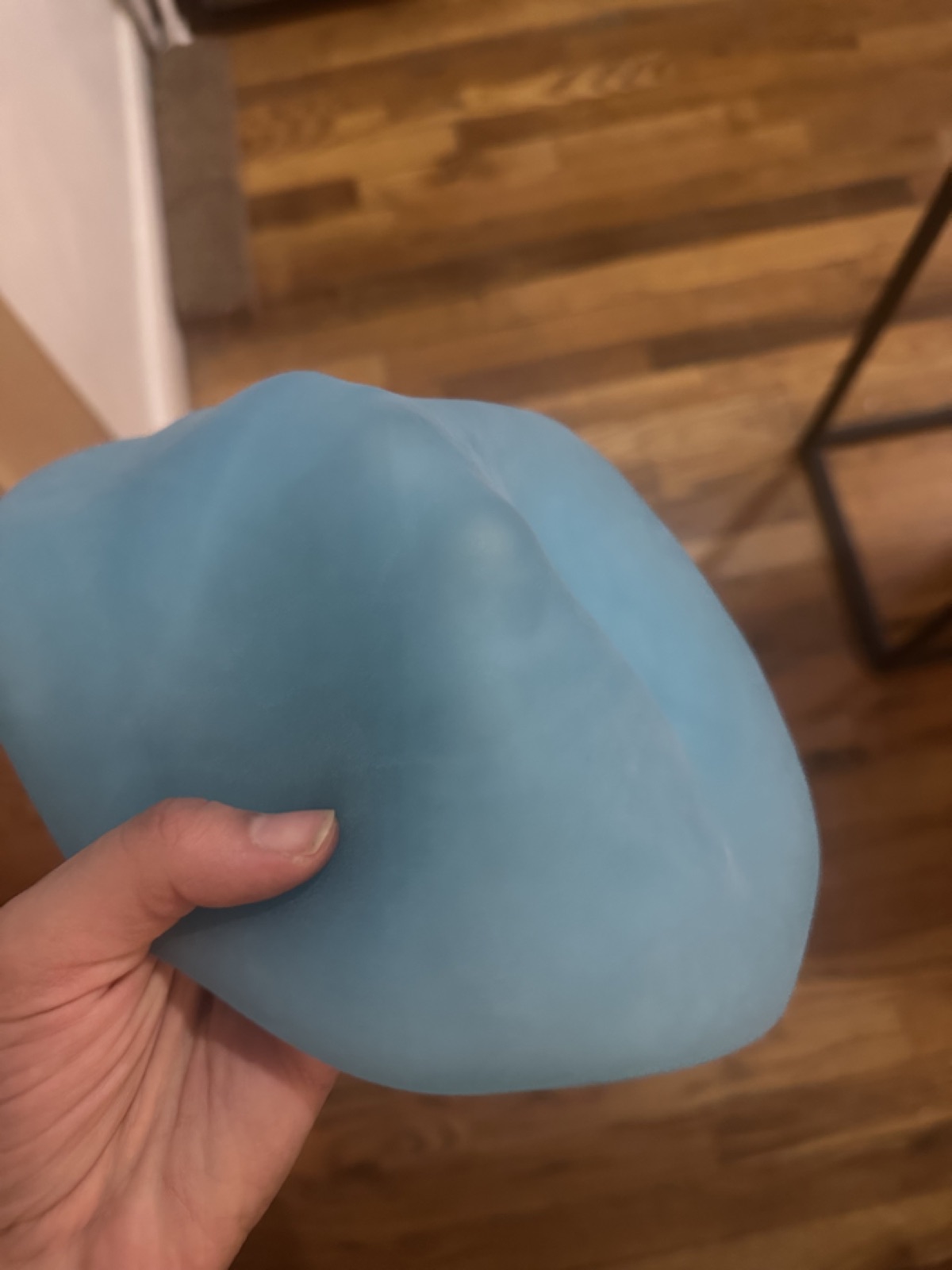 The translucent blue rubber skin held in one hand, without electronics