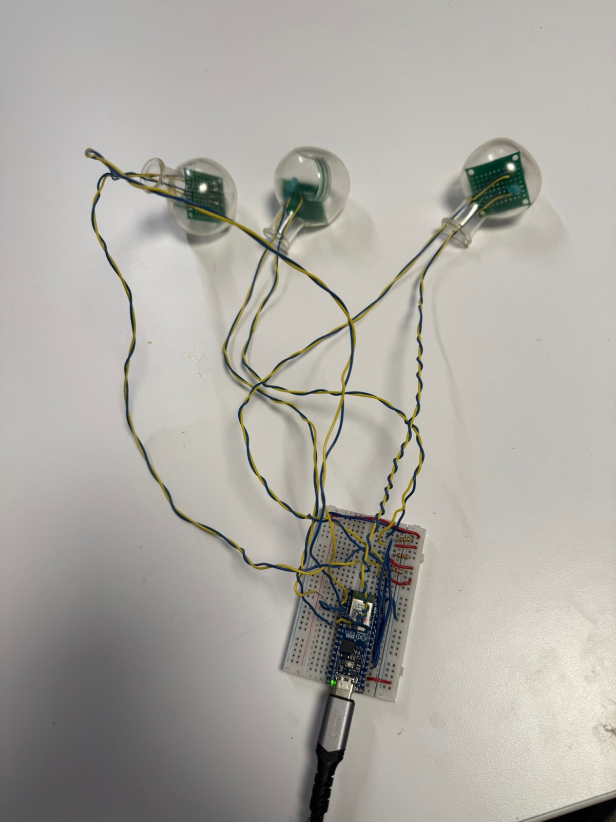 Three sensor pods wired to an Arduino on a breadboard during early testing